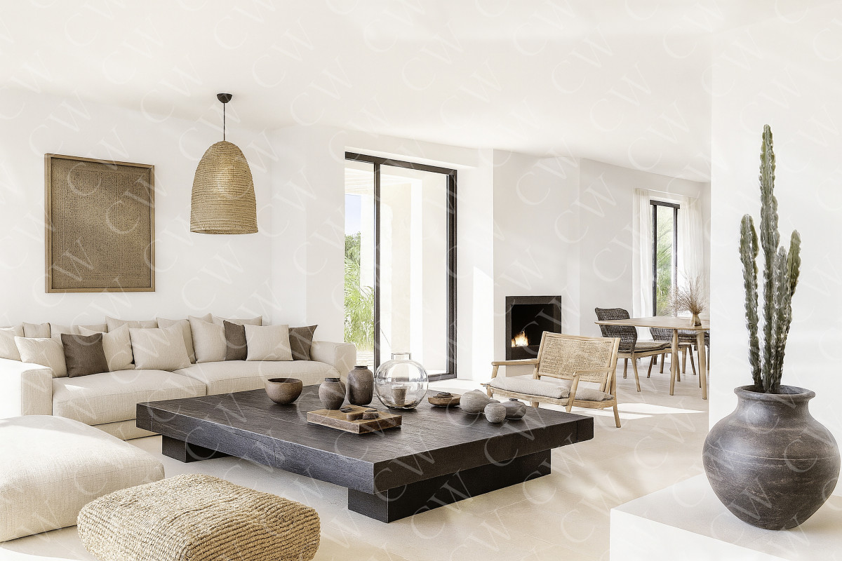 Helles, skandinavisches Wohnzimmer mit großem Sofa, Holztisch und Naturdeko.