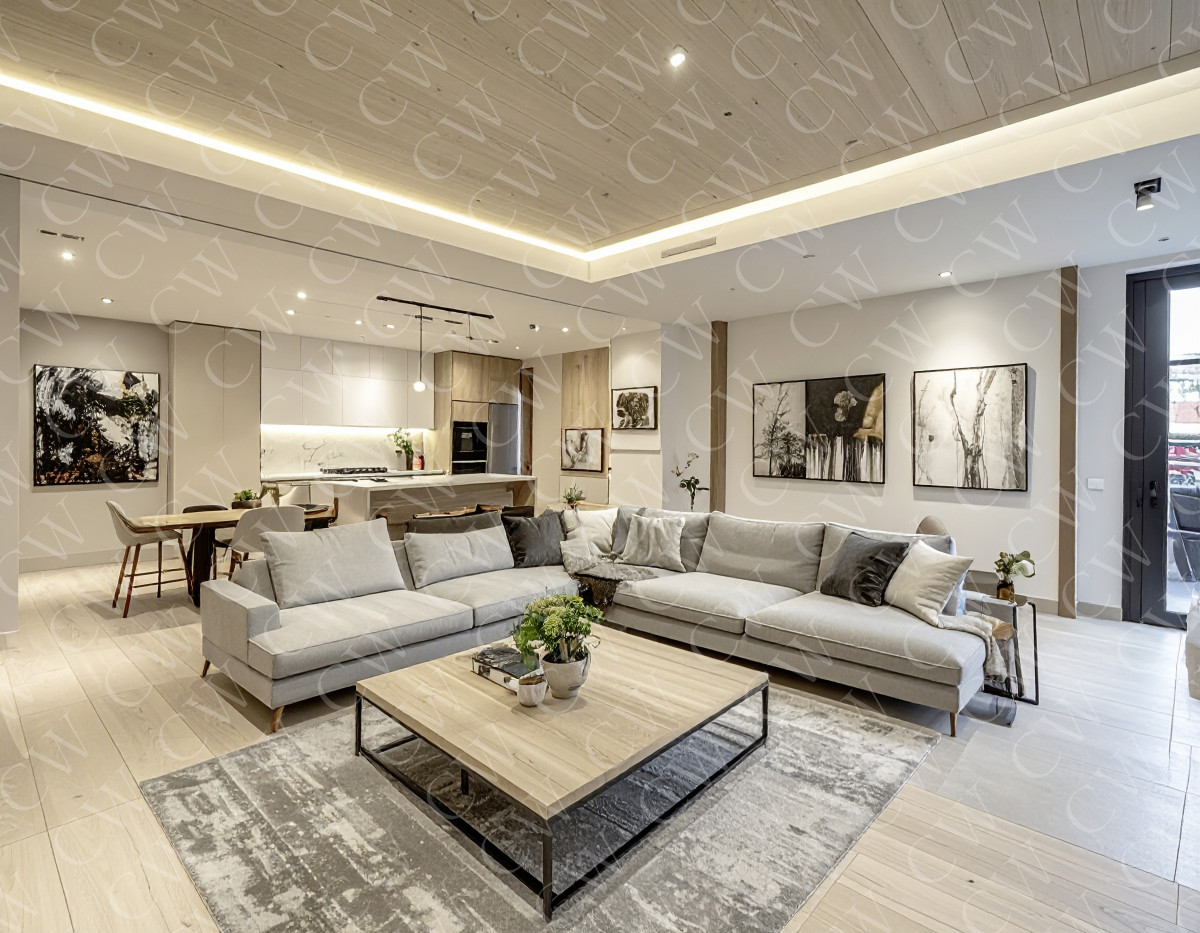 Modernes Wohnzimmer mit heller Couch, Holztisch und offener Küche im Hintergrund