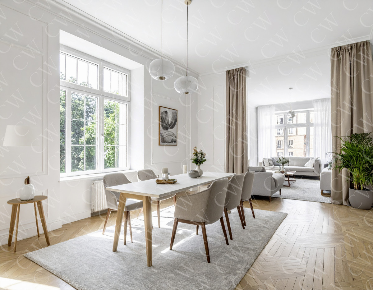 Helles modernes Esszimmer mit Holztisch, grauen Stühlen und Blick ins Wohnzimmer.