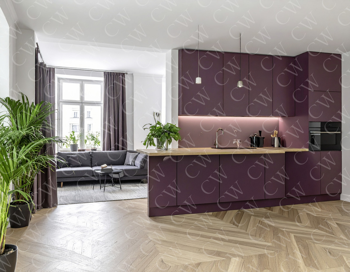 Offene moderne Küche mit lila Schränken, heller Holzarbeitsplatte und gemütlicher Sitzecke.